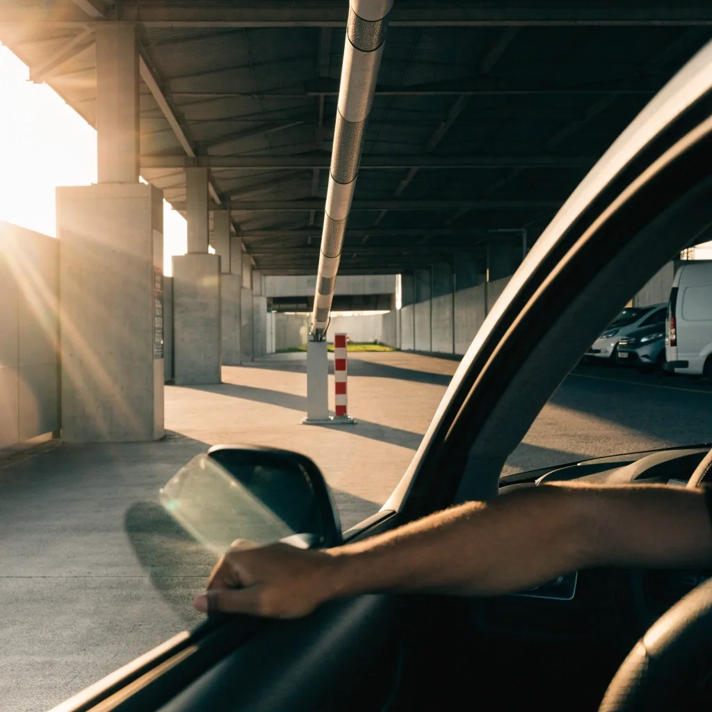 Driver entering a pre-booked domestic car park entry lane with boom gate
